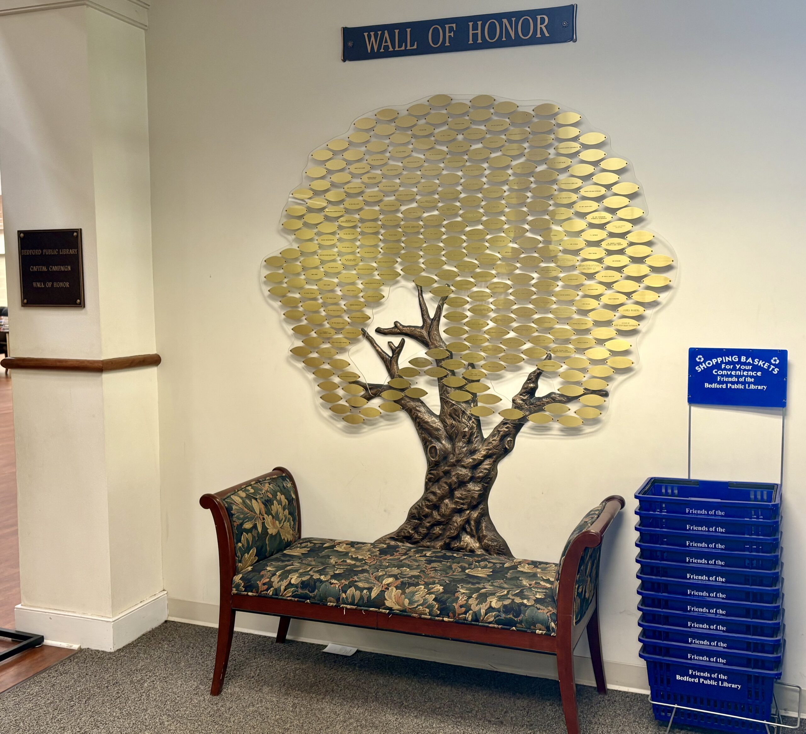 Wall of Honor in Bedford Central Library showing leaves engraved with names of donors.